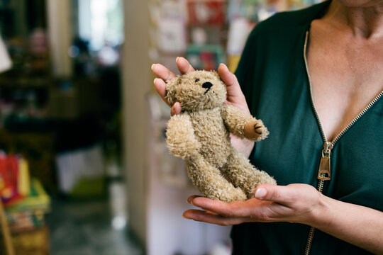 Close Up Of Shop Owner Holding Stuffed Bear
