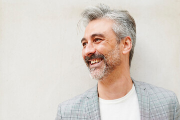 Laughing businessman standing outside