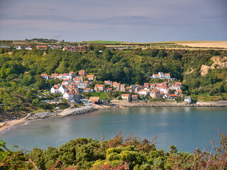 On a sunny day at the end of summer, an aerial view of the popular tourist destination of Runswick Bay on the North Yorkshire coast in England, UK