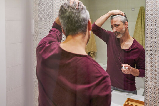 Man looking at his hairline