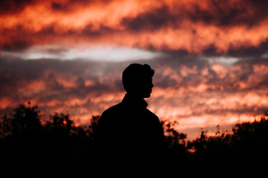 Man's Silhouette Against Sunset