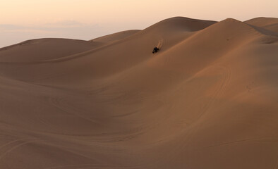 Fototapeta na wymiar Riding the dunes at sunrise