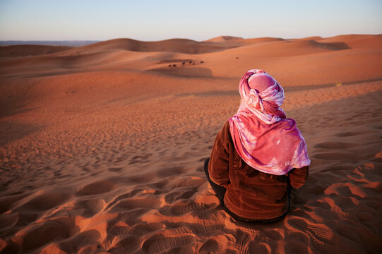 Young woman watch sunrise sand dunes
