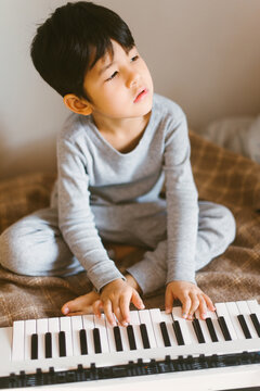 Little kid playing synth