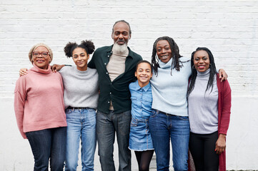 Smiling family standing outside