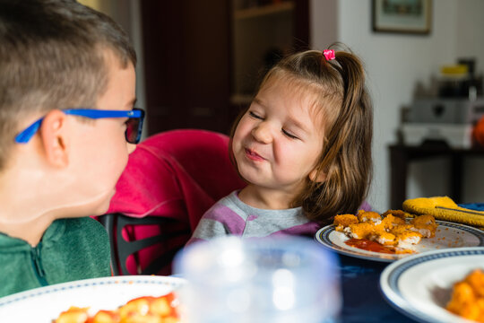 Toddler communicating with brother during lunch