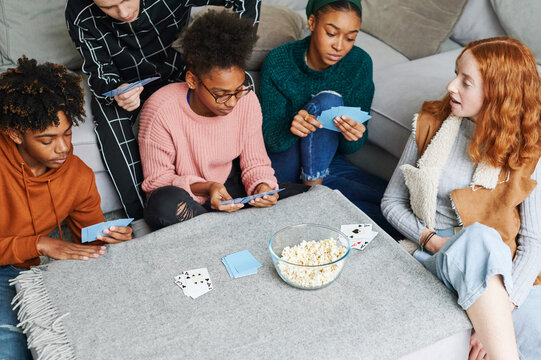 Teens hanging out and playing cards