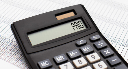 A calculator with the word PAID on the display