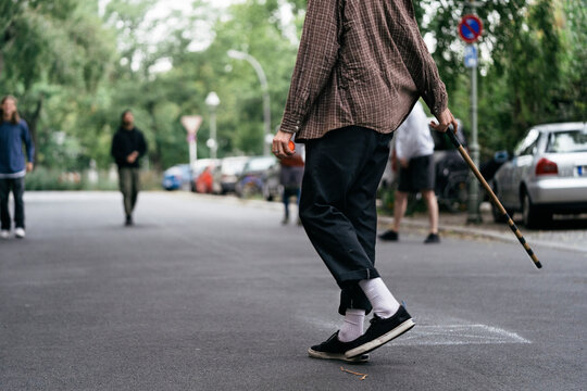 Guys In Street Getting Ready To Continue Game Of Stickball