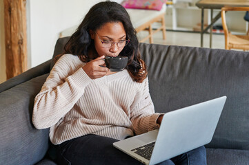 Woman having coffee and working online