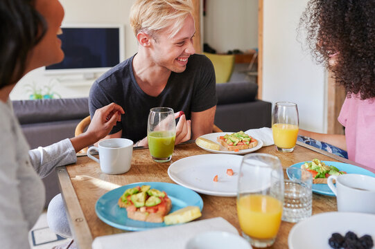 Friends laughing over a healthy breakfast