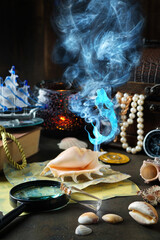 little mermaid, mermaid's tear, pirate items on a dark background, treasure chest, maps. Concept...