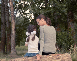 Little girl with her mother in nature
