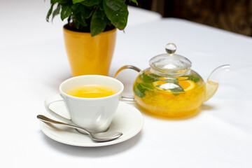 Teapot with orange tea sea ​​buckthorn cup of tea