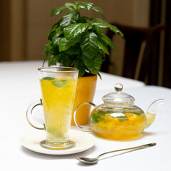 Teapot with orange tea sea ​​buckthorn cup of tea