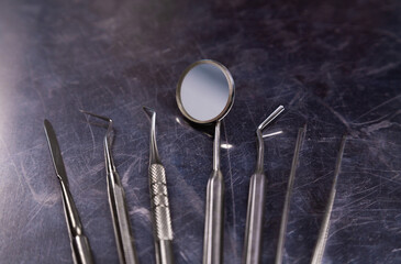 Set of dental instruments on metall background