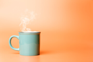 Cup minimal concept. Cup with hot coffee or tea on a blank colored background.