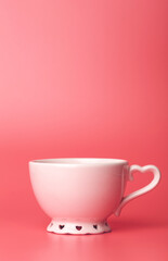 Cup minimal concept. Cup with hot coffee or tea on a blank colored background.