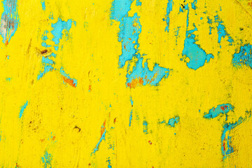 Old painted wood. Old peeling yellow paint with texture on wooden background