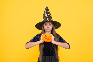 demoness. jack o lantern. happy halloween. child in witch hat. kid hold spooky pumpkin. witchcraft and enchantment. childhood autumn holiday. teen girl ready to celebrate. costume party fun