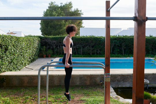 Fit girl working out on parallel bars