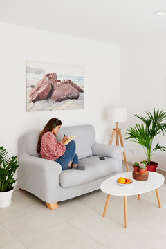 Woman writing in her journal at home