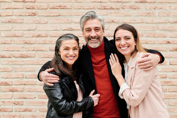 Mature friends smiling together outside