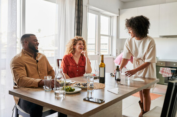 Woman clearing up after dinner with friends