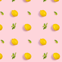 Bright pattern of fresh whole lemons and mint on a pink background. Citrus, vitamin C, fruit.