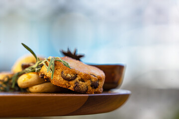close up of assorted cookies on tray with nuts and chocolate pieces