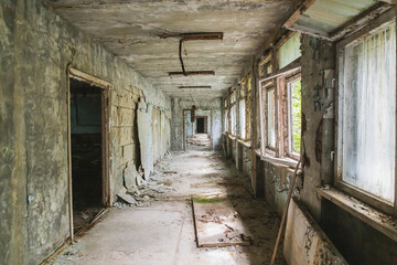 Fototapeta na wymiar Scary corridor in an abandoned school in Pripyat