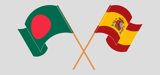 Crossed and waving flags of Bangladesh and Spain