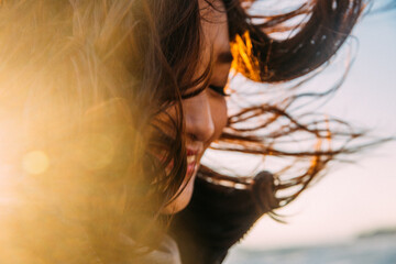 Fototapeta premium Young women feel winter wind on the beach