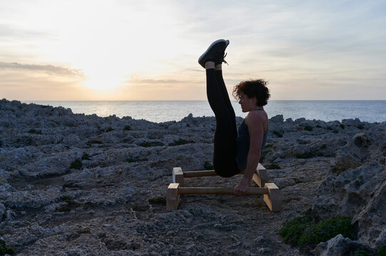Girl working out by the ocean at dusk