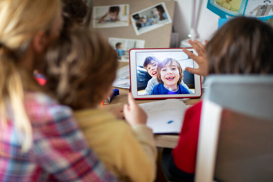 Mother and her kids doing video chat with their friends