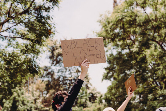 Protester holding sign that says ""Black Lives Matter""