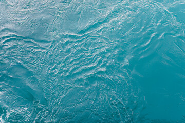 Fototapeta na wymiar Blue sea surface with waves and ripples. Top view