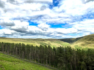 Fototapeta na wymiar Looking over to the trees, valleys and moors, from, Greenfield Road, Oldham, UK