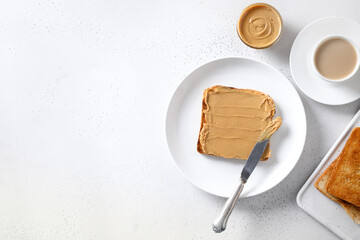 Crispy toast with peanut paste for healthy breakfast on white background. View from above. Copy space.