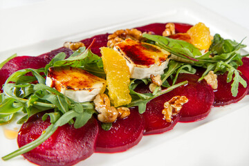 Beetroot carpaccio with goat cheese, rocket leaves and walnuts