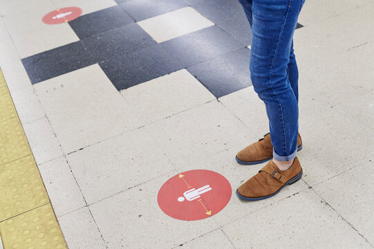 Man physical distancing on a train platform