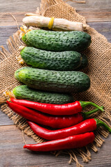 horseradish, dill, pepper, cucumbers for cucumber on a wooden table