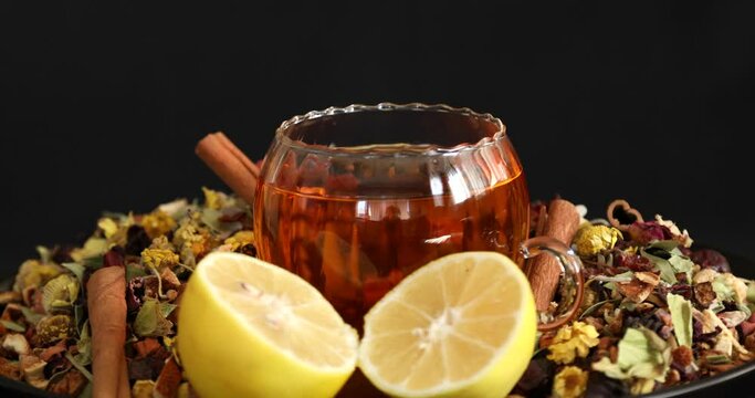 Cup of healthy tea with different kind of dryed herbs and flowers