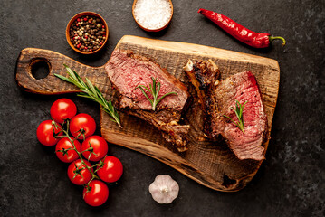 Baked beef on the bone with spices on a stone background
