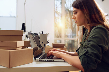 Seamstress works to new clothes ordered by internet client