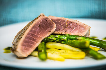 Tuna steak with asparagus and bean pods. The food in the restaurant. Food styling and restaurant meal serving.