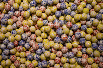 Colored ceramic balls in a box (top view)