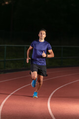 Man training to run on a track and field