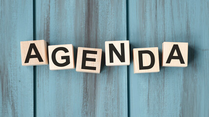 concept of the word AGENDA on cubes on a wooden background