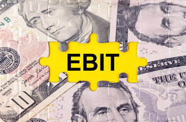 Puzzle with the image of dollars in the center of the inscription -EBIT